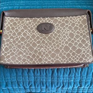 Nina Ricci Vintage Clutch. Has strap to hold on back. Could also be cosmetic bag